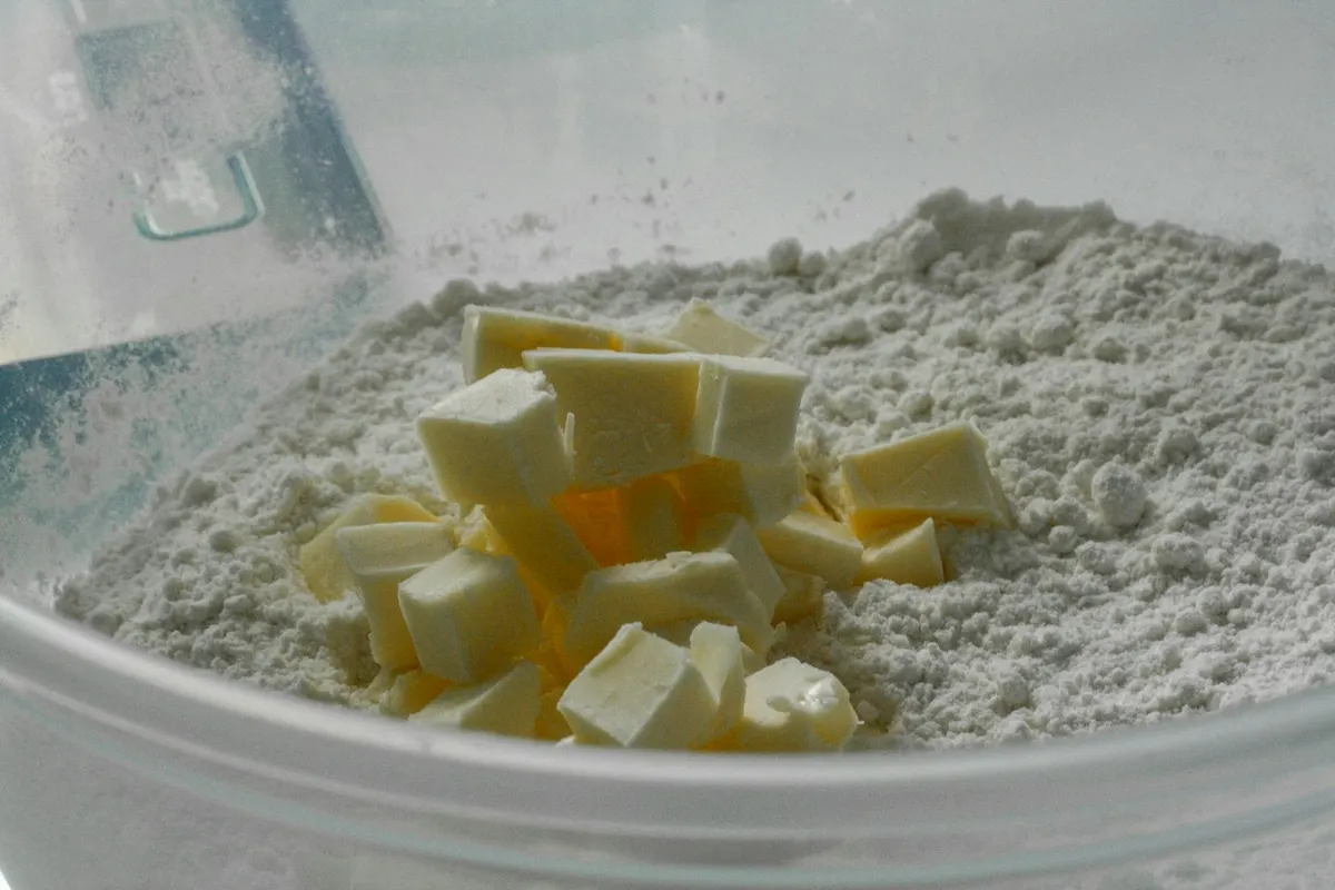 Cubes of cold butter on a bowl of flour, ready to be rubbed in for scones or pastry